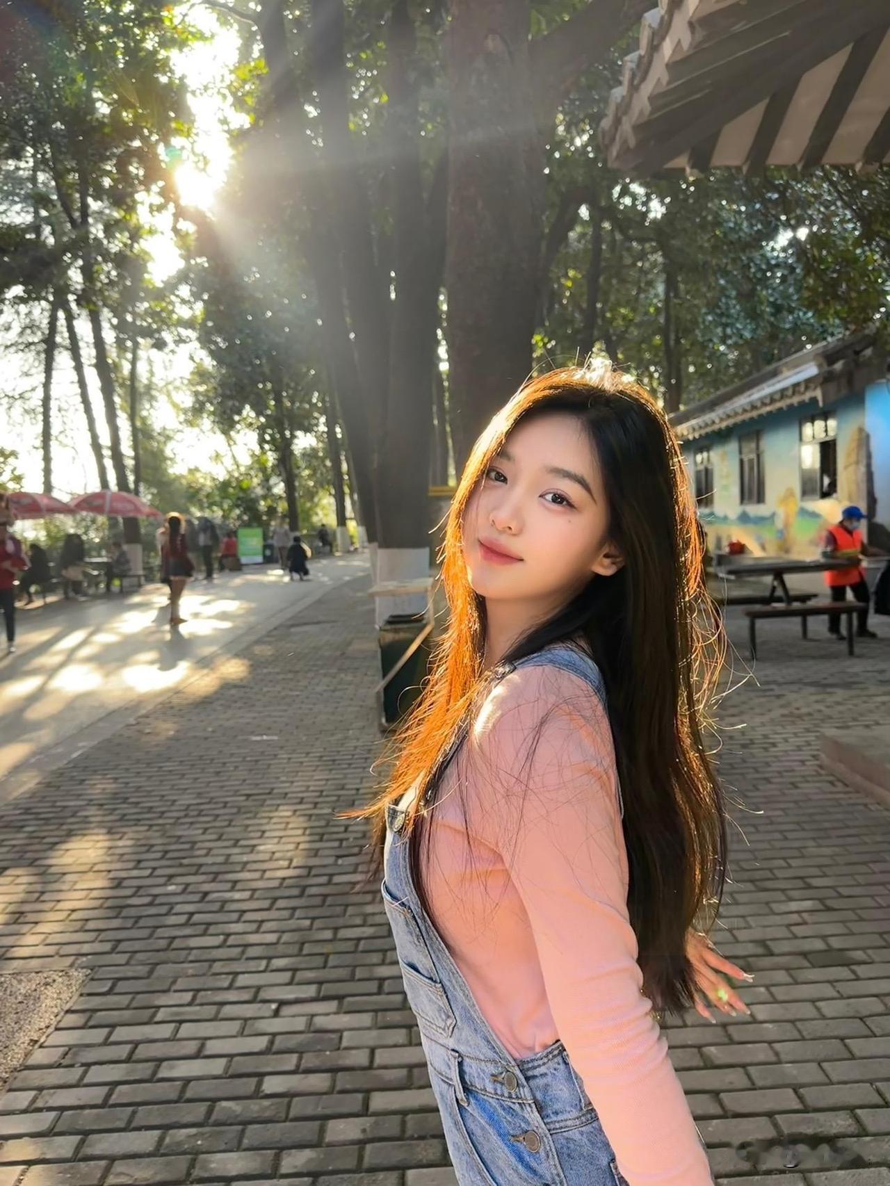 阳光洒落，少女漫步在林荫小道，笑靥如花。