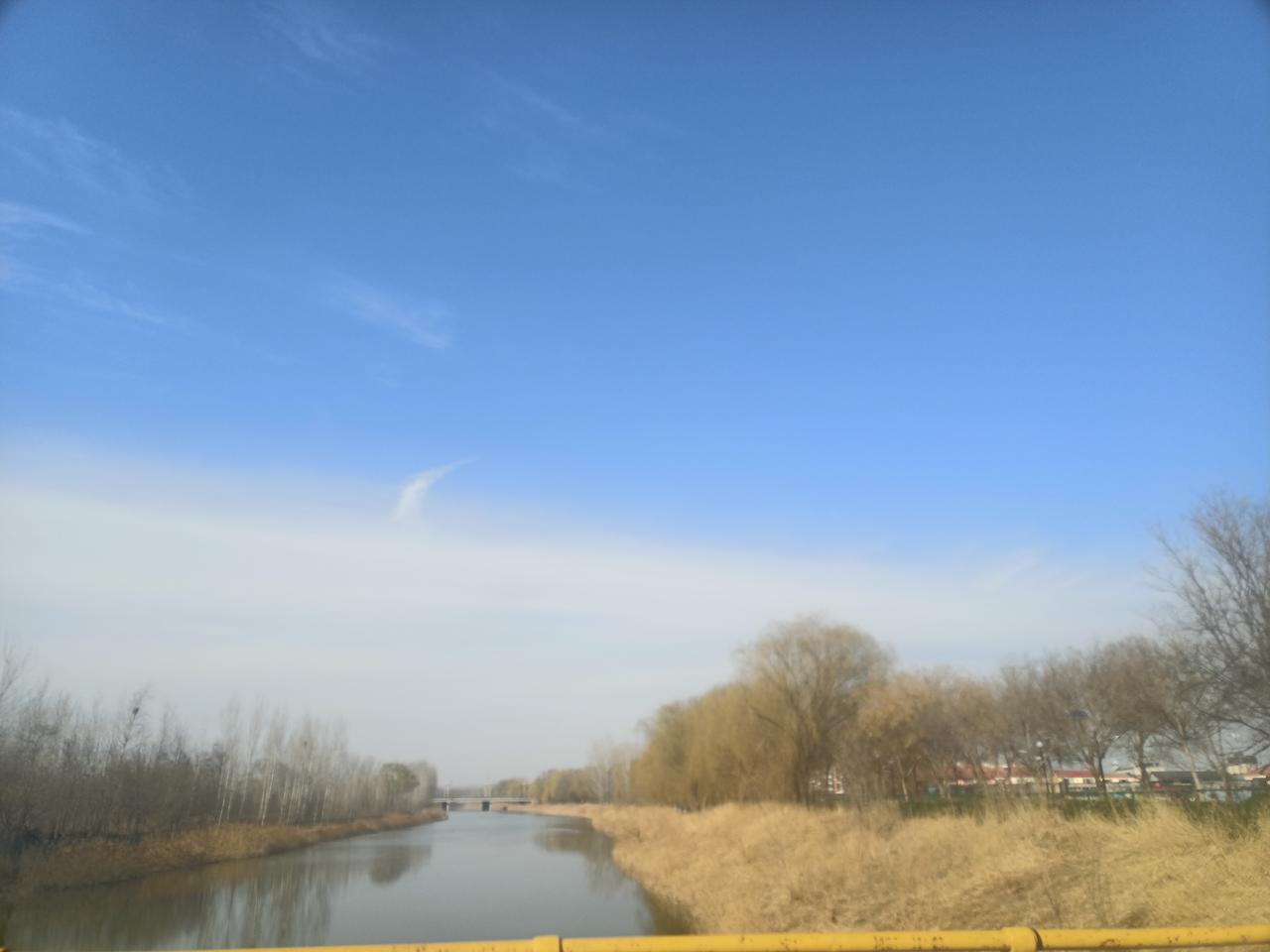 寻春踏青随手拍天高云淡风轻日暖。河水清澈见底，岸边杨柳依依，行人来往如织，一片繁