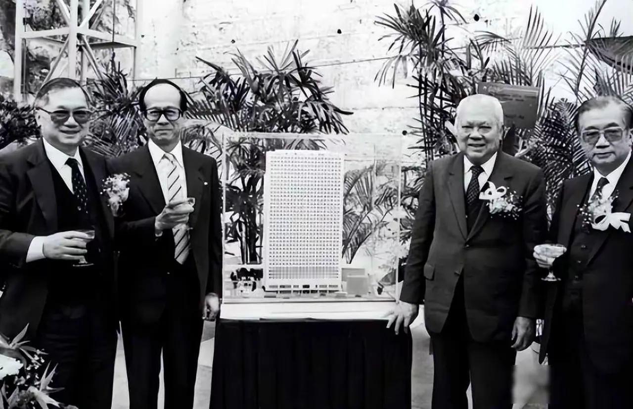 四位西装革履的男士在模型前合影。这四位是最有实力的经济超人吧。能叫出他们的名字吗