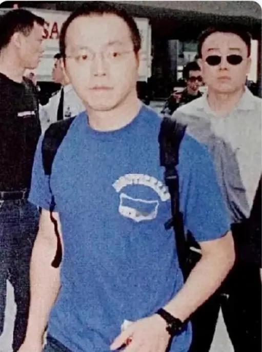 1999年深圳演出的窦唯，年轻时尚，一件蓝色圆领体恤衫牛仔裤，标志性的平头眼镜，