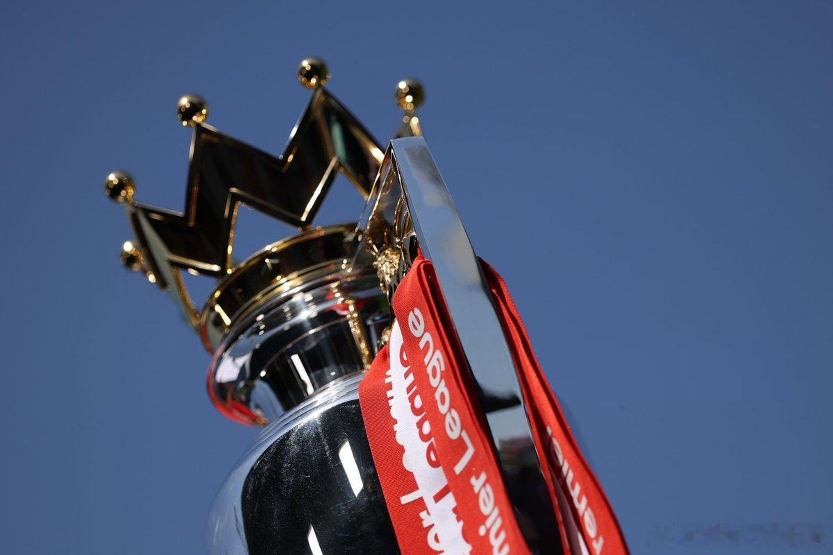 Premier League trophy  dressed in red an