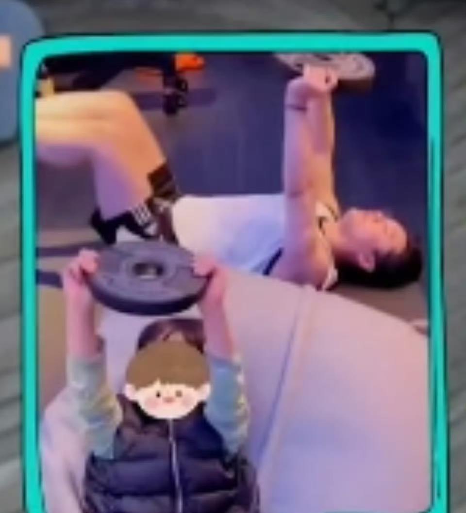 黄晓明在节目上晒出一张儿子陪他一起减肥的照片，照片中黄晓明举着哑铃片躺在地上，旁