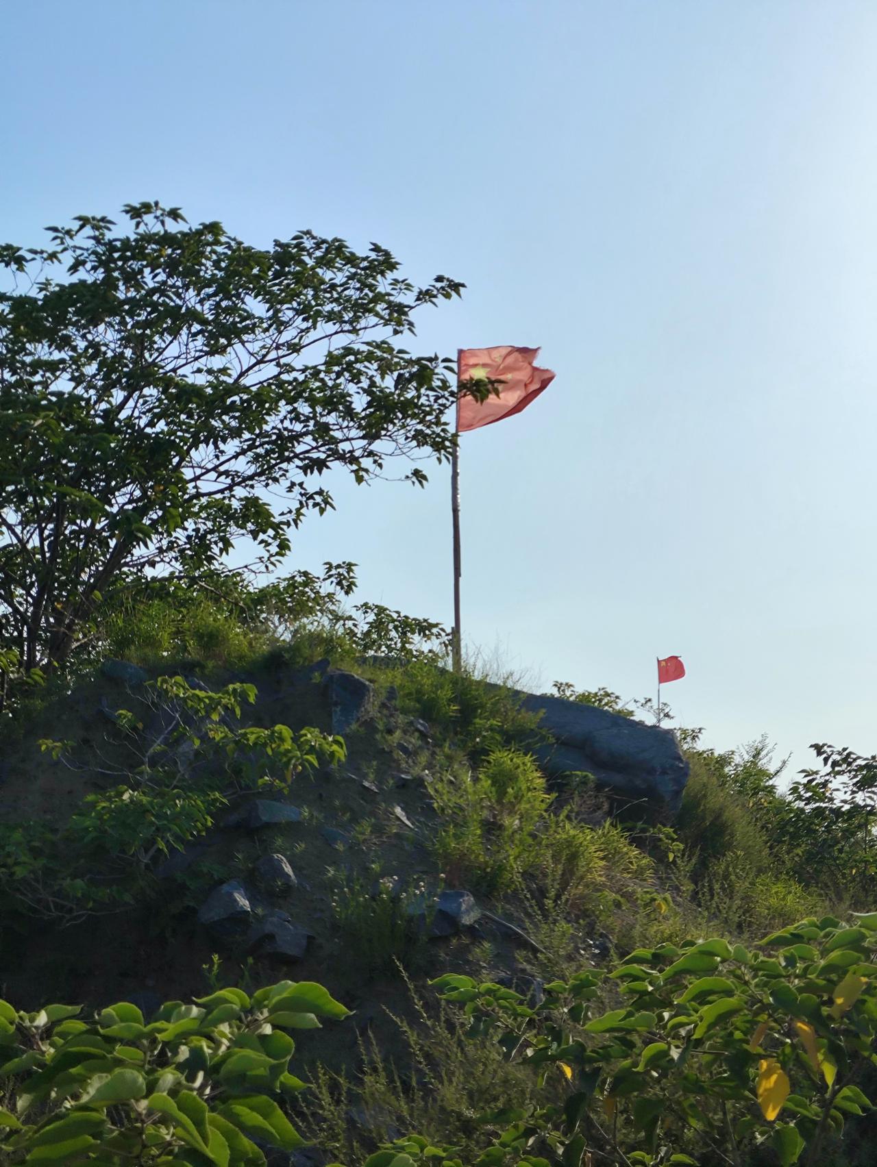 在济南卧牛山的高顶上，五星红旗正迎风飘扬。之前看过卧牛山公园的航拍，那景象就像崇