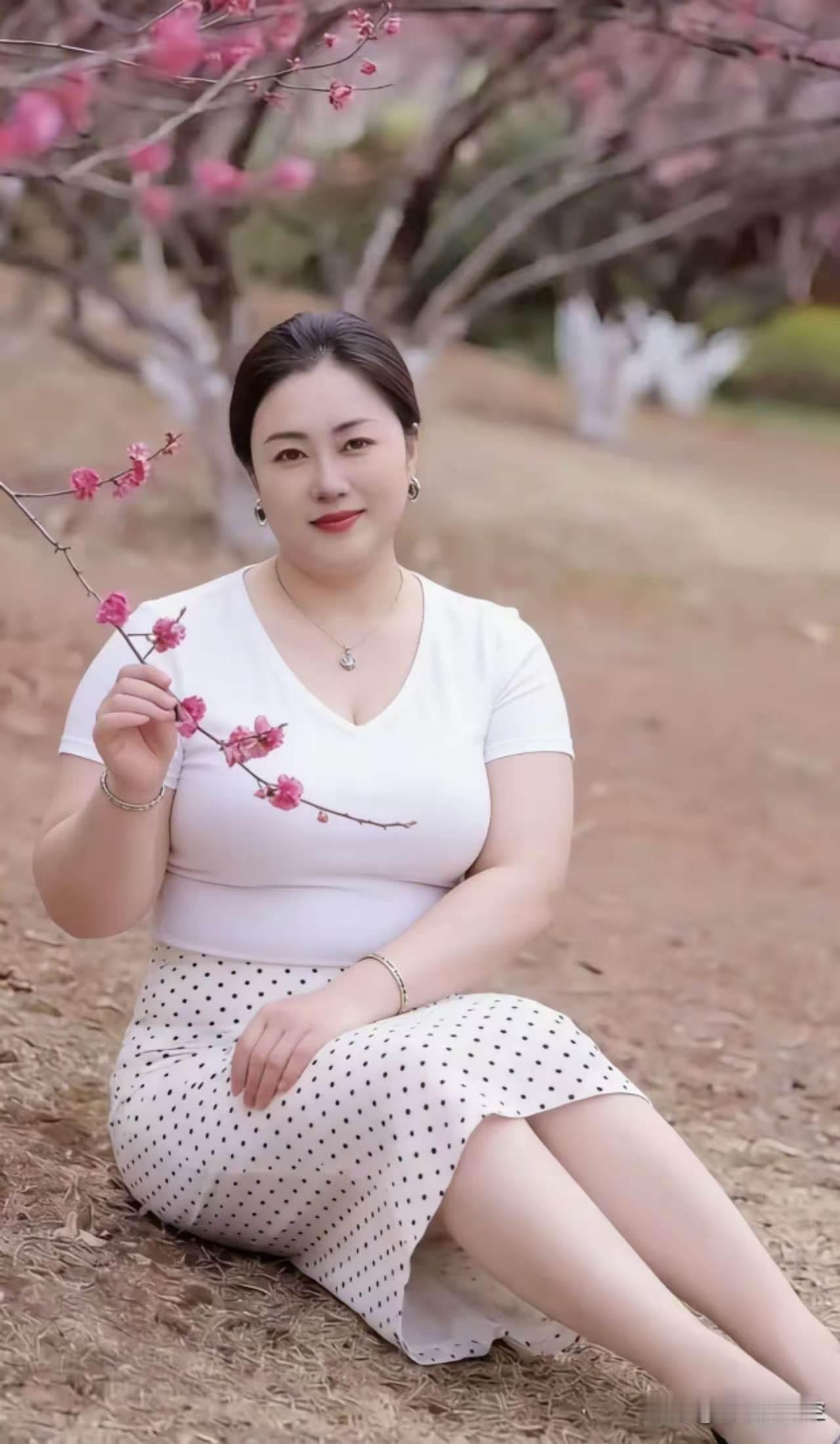 捣练子·桃下佳人
姿丰润，素衣清。
波点罗裙坐翠坪。
手握桃花妆饰雅，
一身温婉