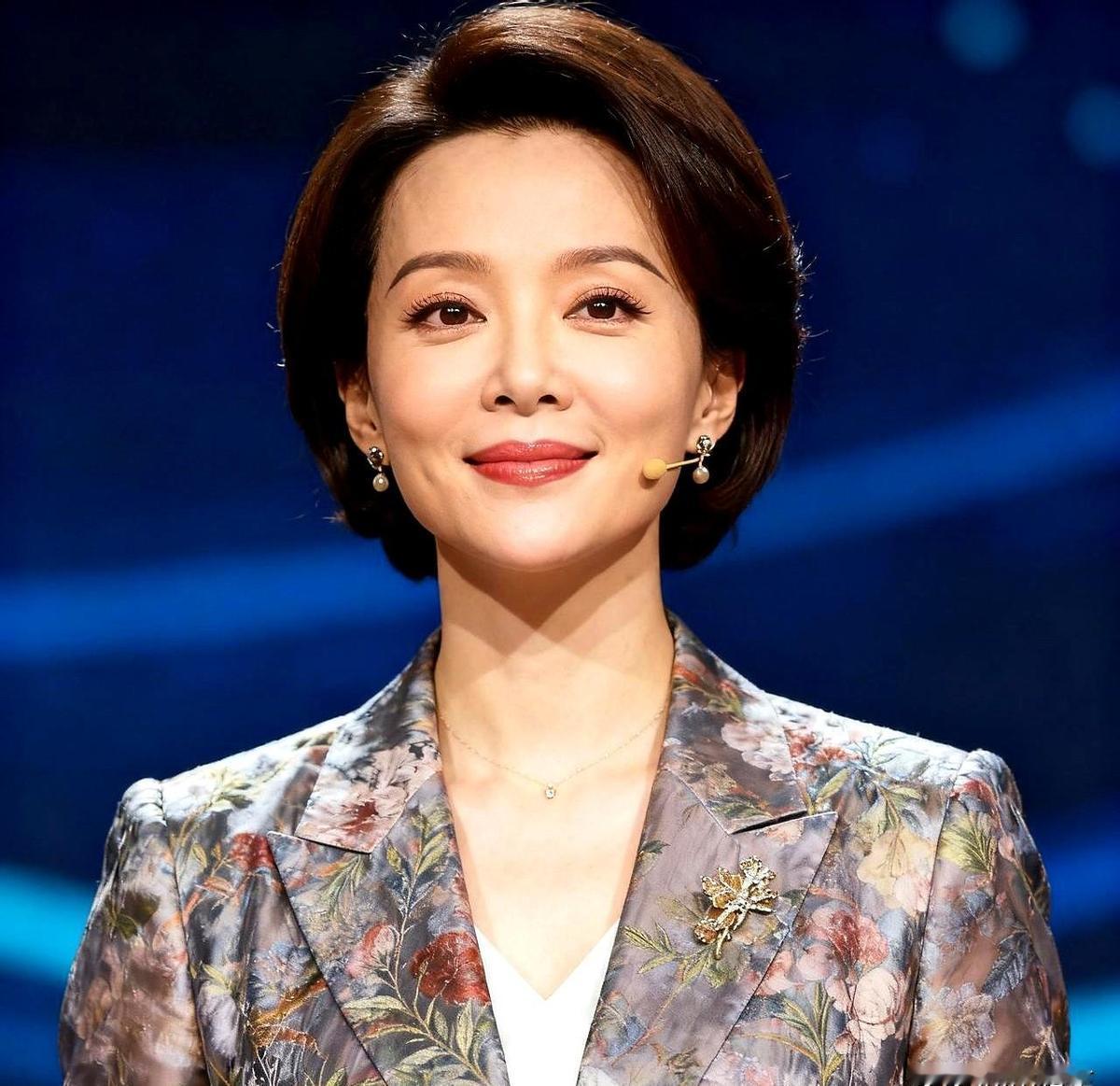 她没穿礼服，没戴项链，就一件旧卫衣，牵着娃在球场边吃煎饼果子。
没人喊她董卿，都