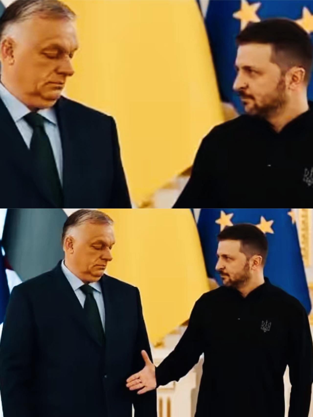 欧尔班面对泽连斯基伸过来的手，面部表情是什么意思呢？
泽连斯基手都伸过来了，欧尔