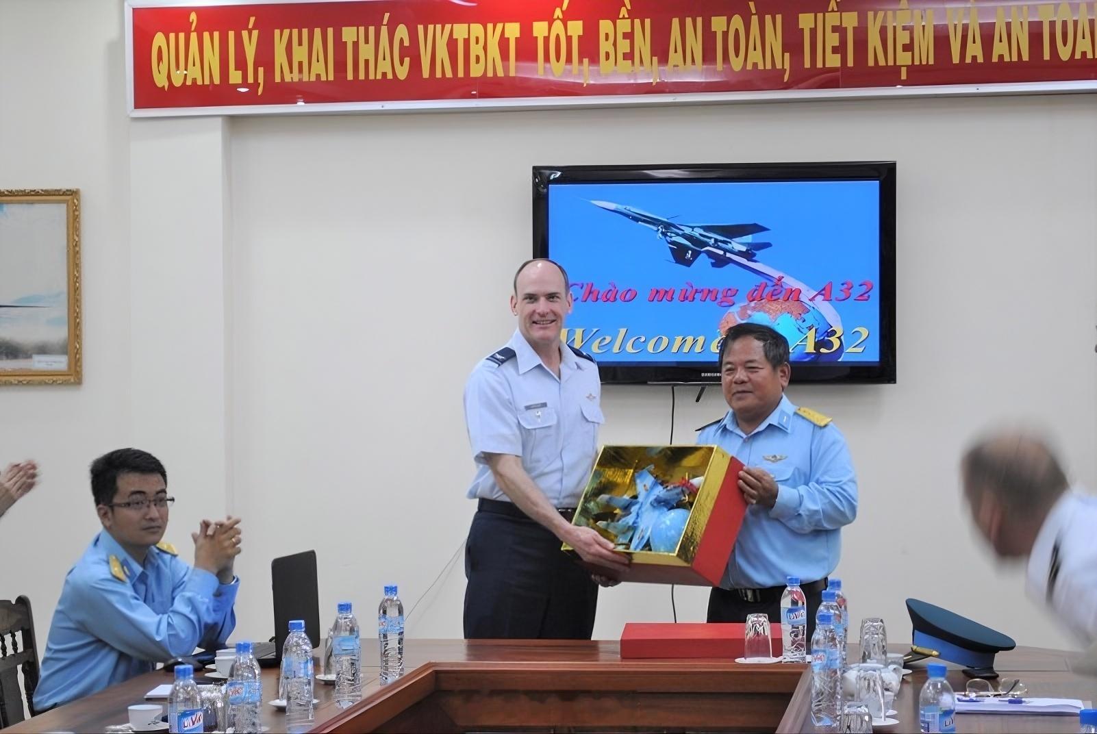 越南人民空军A32工厂的员工正在带领美国空军学院的代表团参观工厂。背景中是一架苏