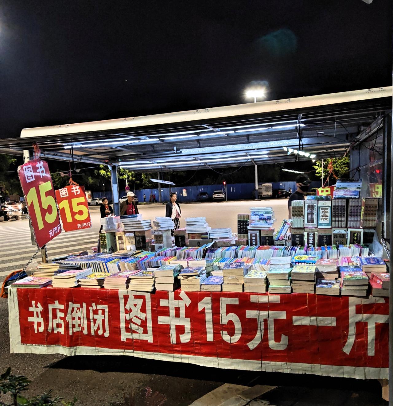 今晚去赶夜市，在喧嚣的夜市摊上 ，我看见了这样一个摊位 ，掏出手机拍下来了。大家