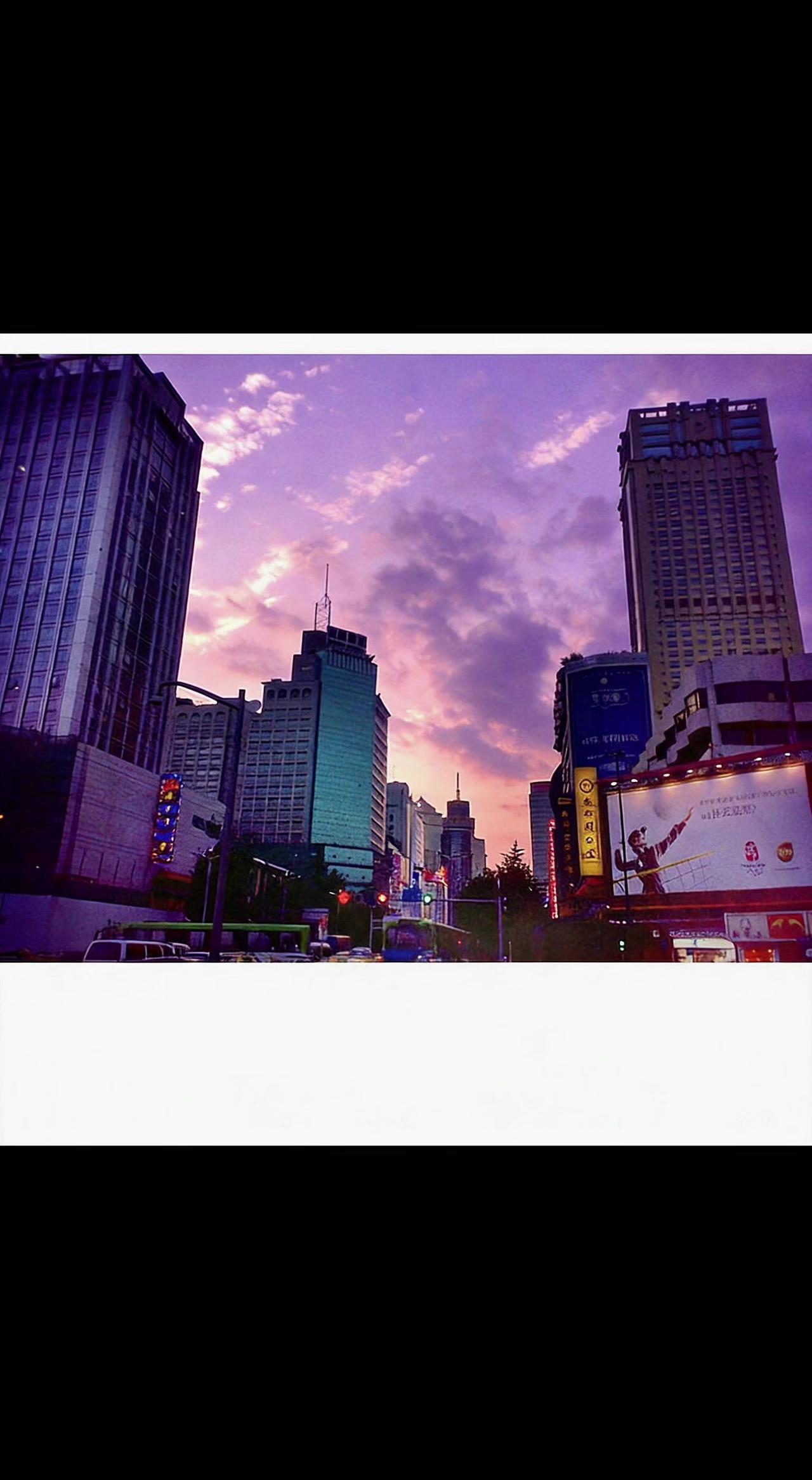 🌆 城市把晚霞揉进玻璃幕墙，车流是流动的星子✨。钢筋森林也会温柔，在暮色里藏起