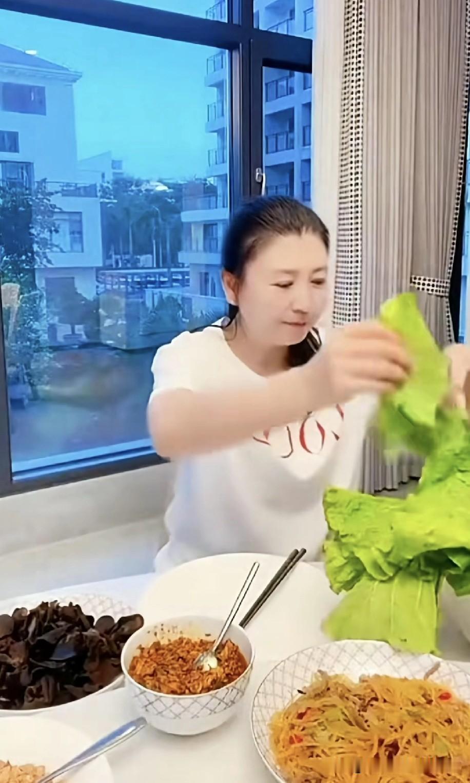 闫学晶在直播间教大伙儿吃东北大包菜，一口一个吃得香，还念叨：“再来一个，太好吃了