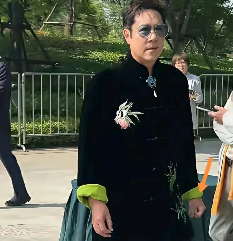 59岁蔡国庆精神饱满北京街头步行时左手握拳头。