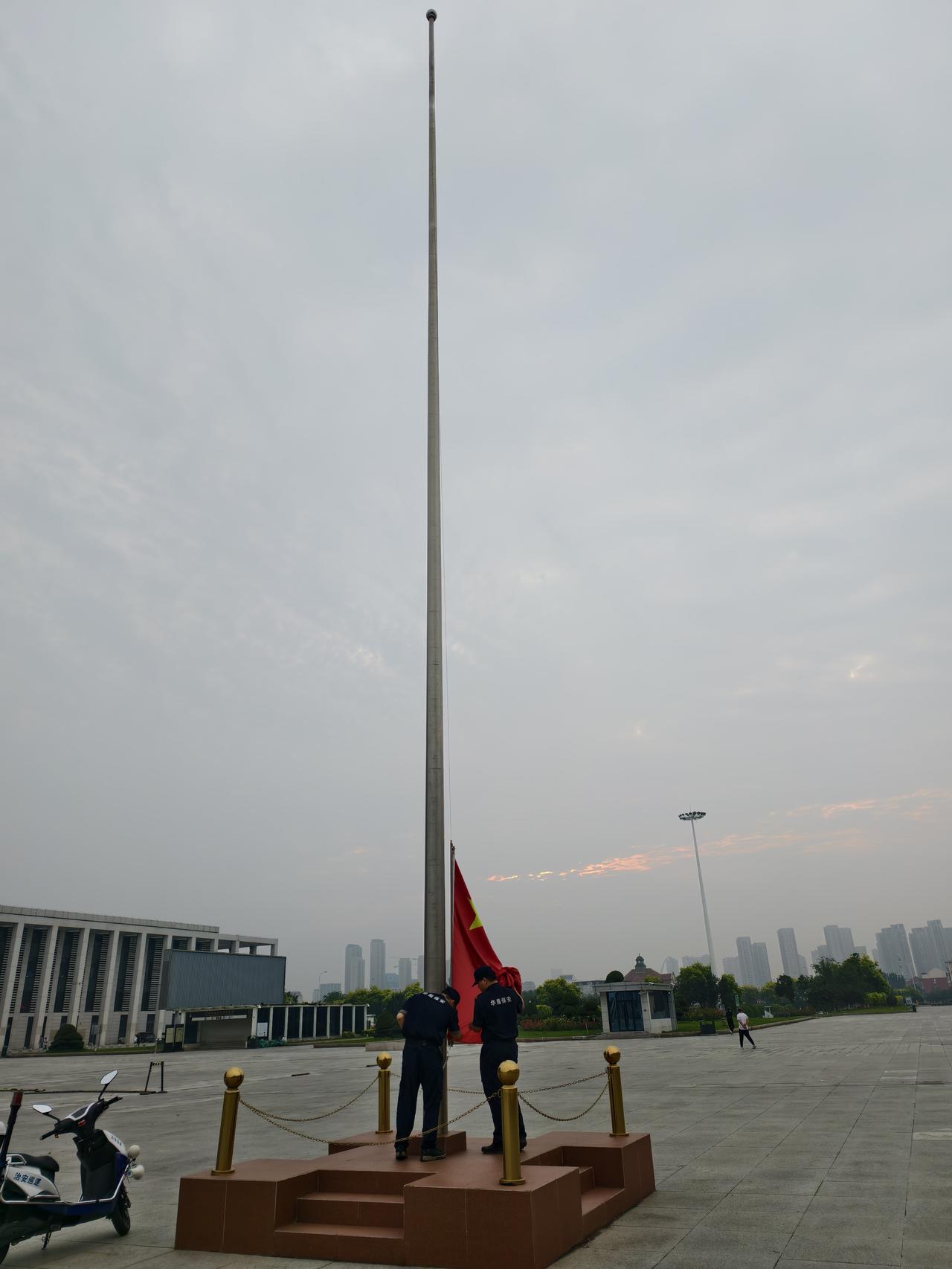 最近早晨跑步路过天津西站南广场，看到两名年轻的保安人员，随着日出在升国旗！