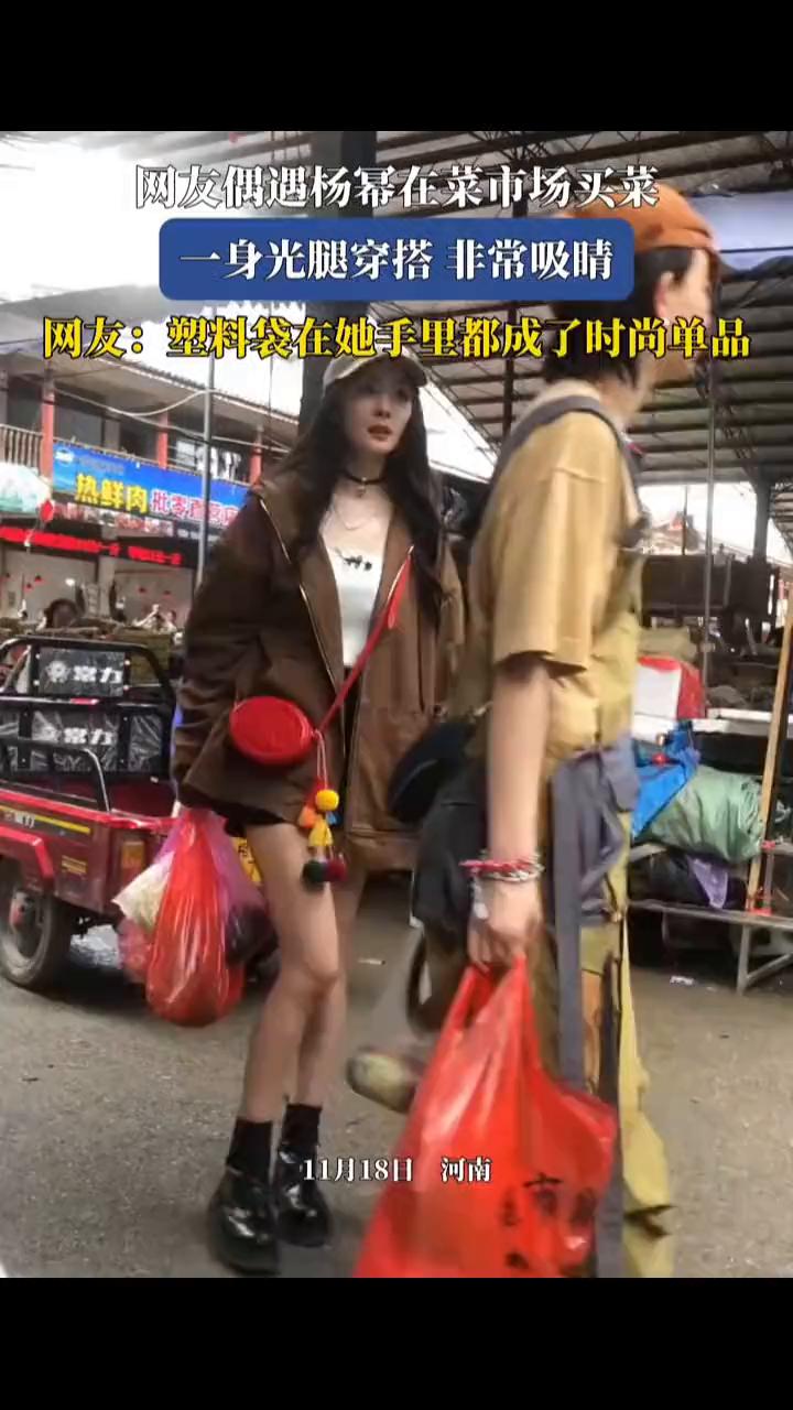 网友偶遇杨幂在菜市场买菜，一身光腿穿搭非常吸睛。
网友：塑料袋在她手里都成了时尚