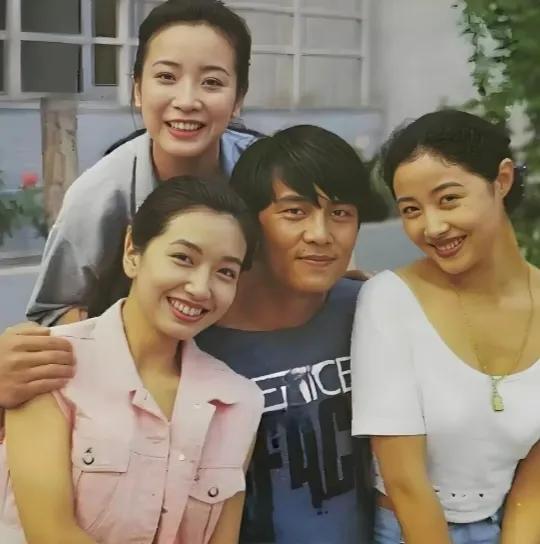 呀！中间这位男的是谁啊！长得不好看，又黑又土，竟然还搂着三位高颜值的美女，看来一