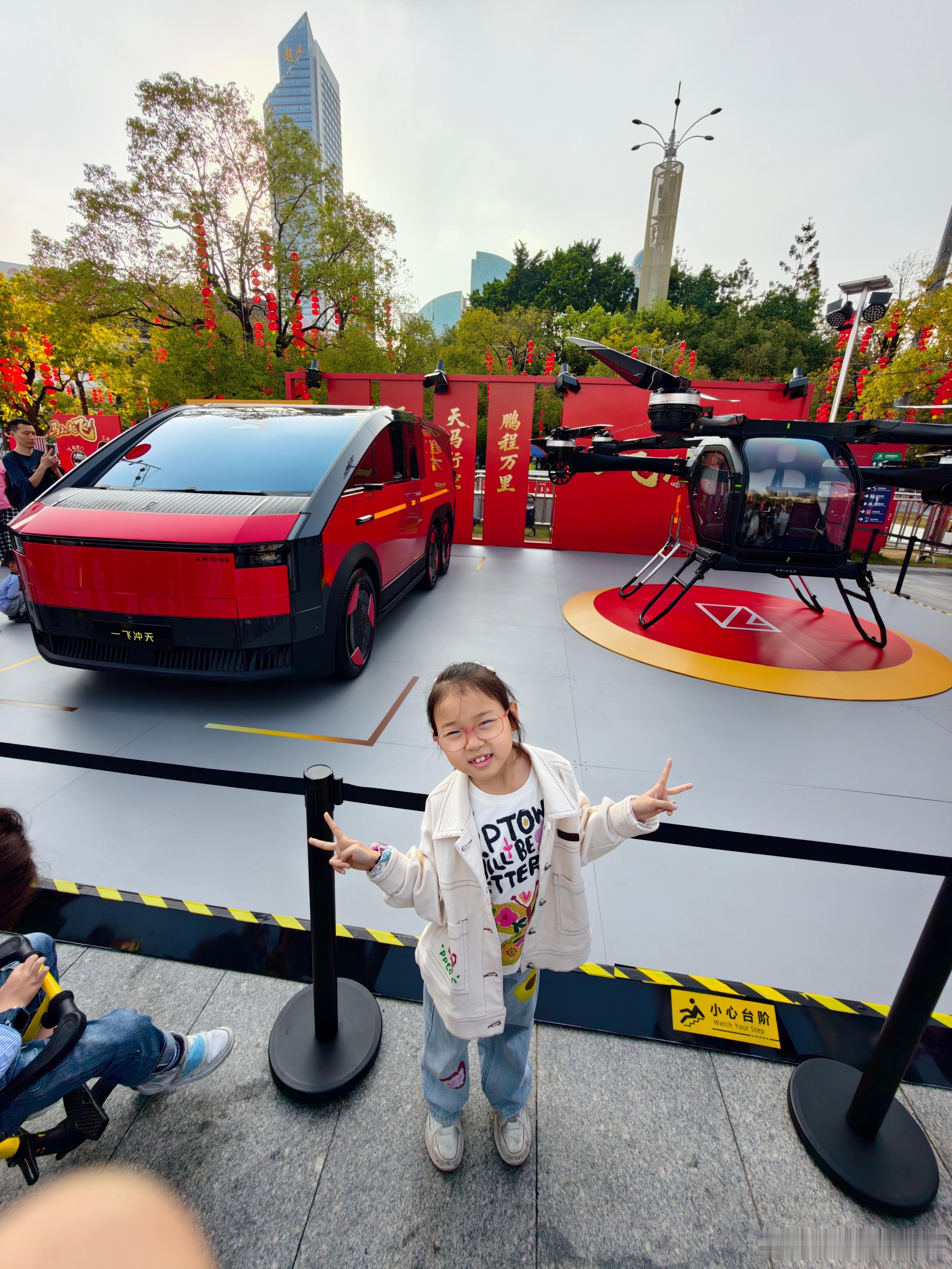 在迎春花市上最瞩目打卡点，我家娃也拿到了飞行汽车的小玩具，抱着睡觉呢！飞行汽车也