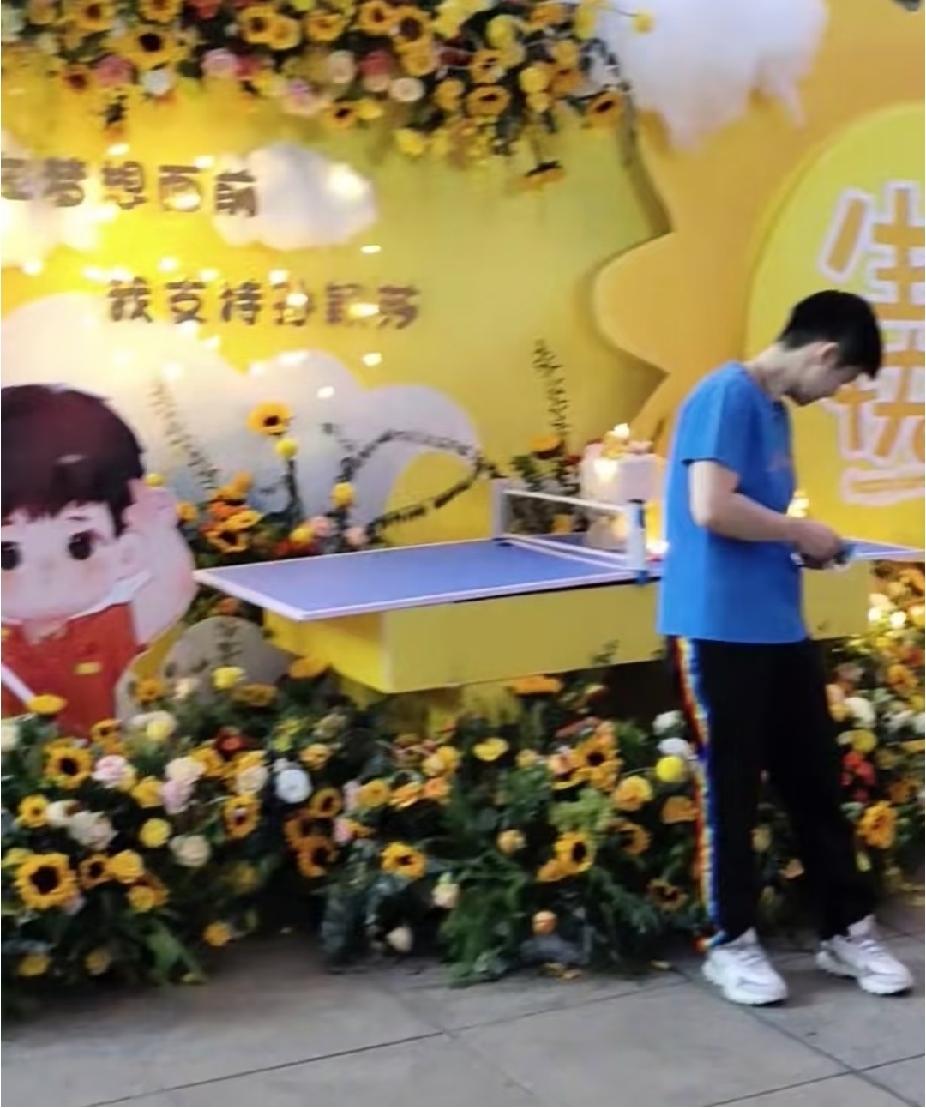 场上小魔王，线下软萌小朋友
 
短发乖乖的，身形看着小小的，站在生日花束旁，稚气