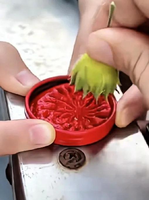 好有创意的原始美妆啊！
用馒头花的果实蘸上红印泥，按在女孩儿的眉心处，一朵红艳艳