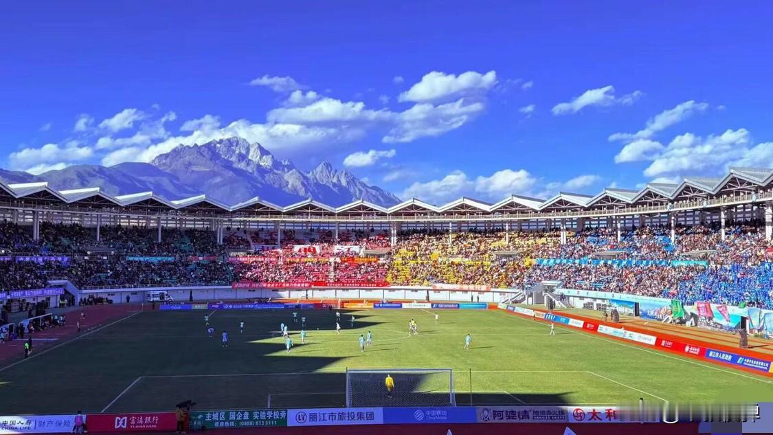 这居然是云南丽江的体育场。蓝天、雪山、白云，这样的球场踢球，发展云南城市超级联赛