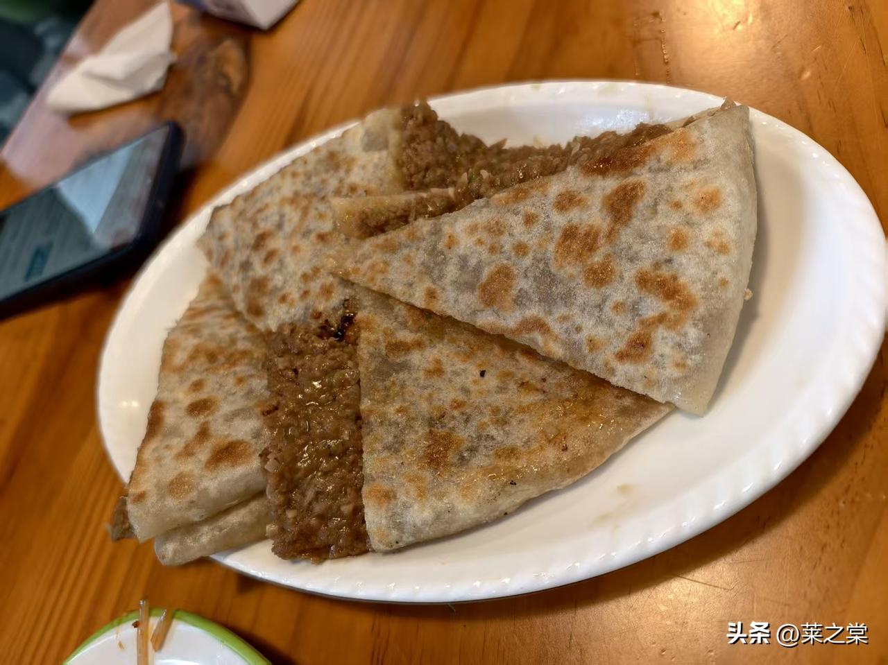 在亦庄逛累了，吃点什么呢？一个小吃店，9张小桌子，上座率蛮高的。香河肉饼、砂锅烩