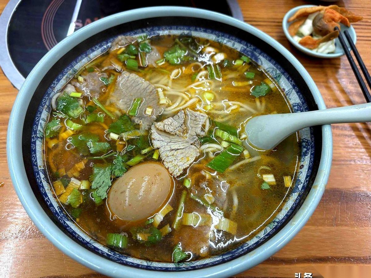 “老板，两碗小份的。”我递过去20块钱。
他头都没抬，指了指墙上的价目表：小份1