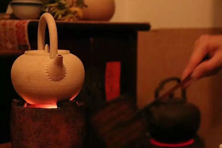 拜年围着火炉喝茶，茶是亲戚自种的，柴草烟火味十足，但有个小老板摆出一副猪不啃狗不