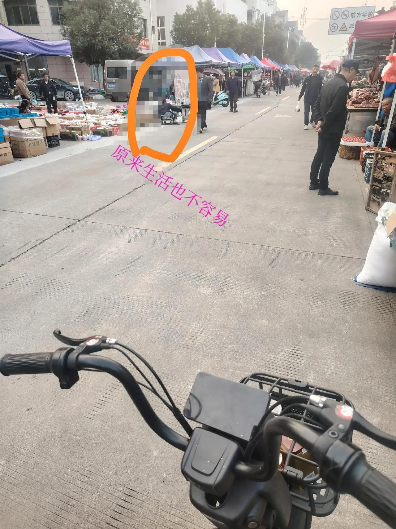 曾经多熟悉的场景如今又真实的显现在我身边。街道上那位坐在滑板车上的残疾人，手上拿