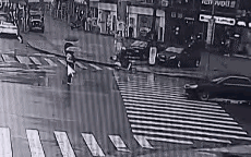 事情可能不是你看到的这么简单。
一个女子手里打着伞，怀里还抱着一个孩子，在她过马