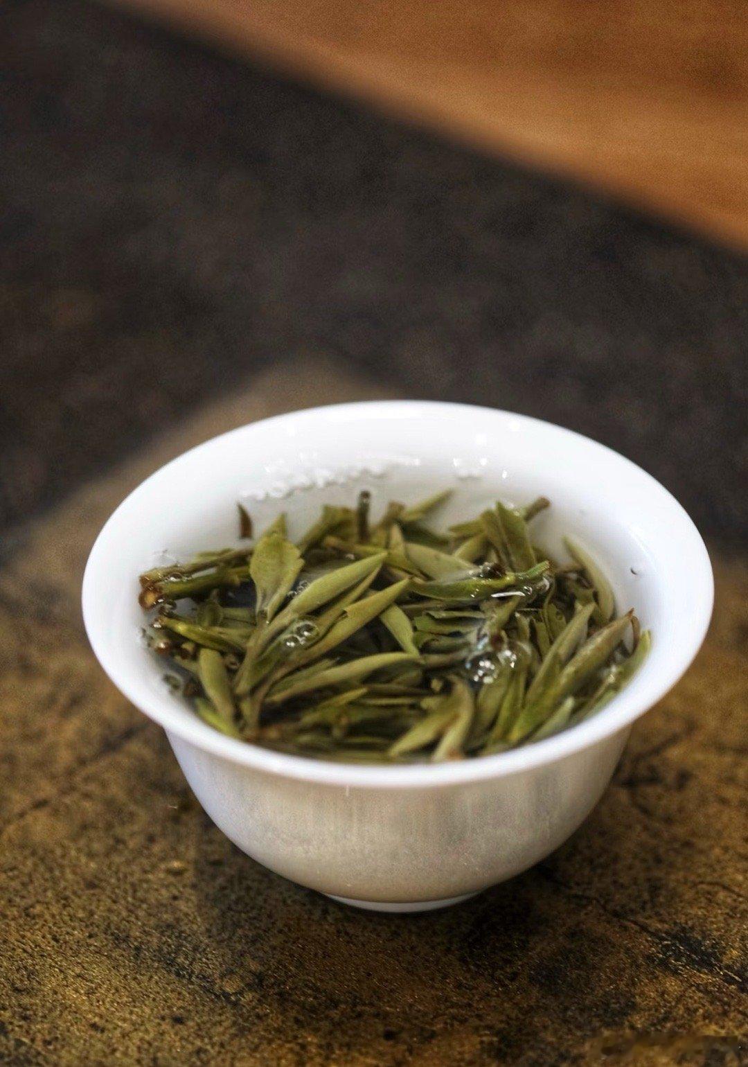 你要写白牡丹，就不能只写白牡丹写春山雾霭里，银毫裹着灰绿的柔软写叶脉微红藏霜雪，