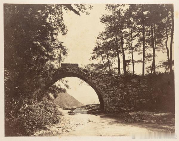 Bridge over stream near waterfall, 'Snow