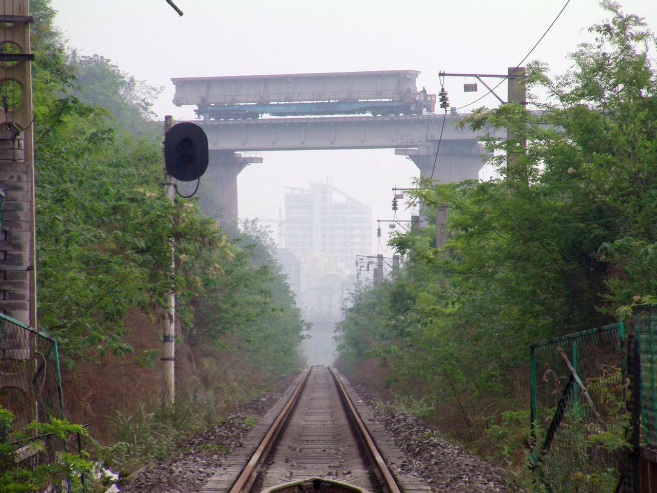 十几年前在襄渝铁路磨心坡站南边与东阳线路所区间以及北碚车站拍过照片，发现远处正对