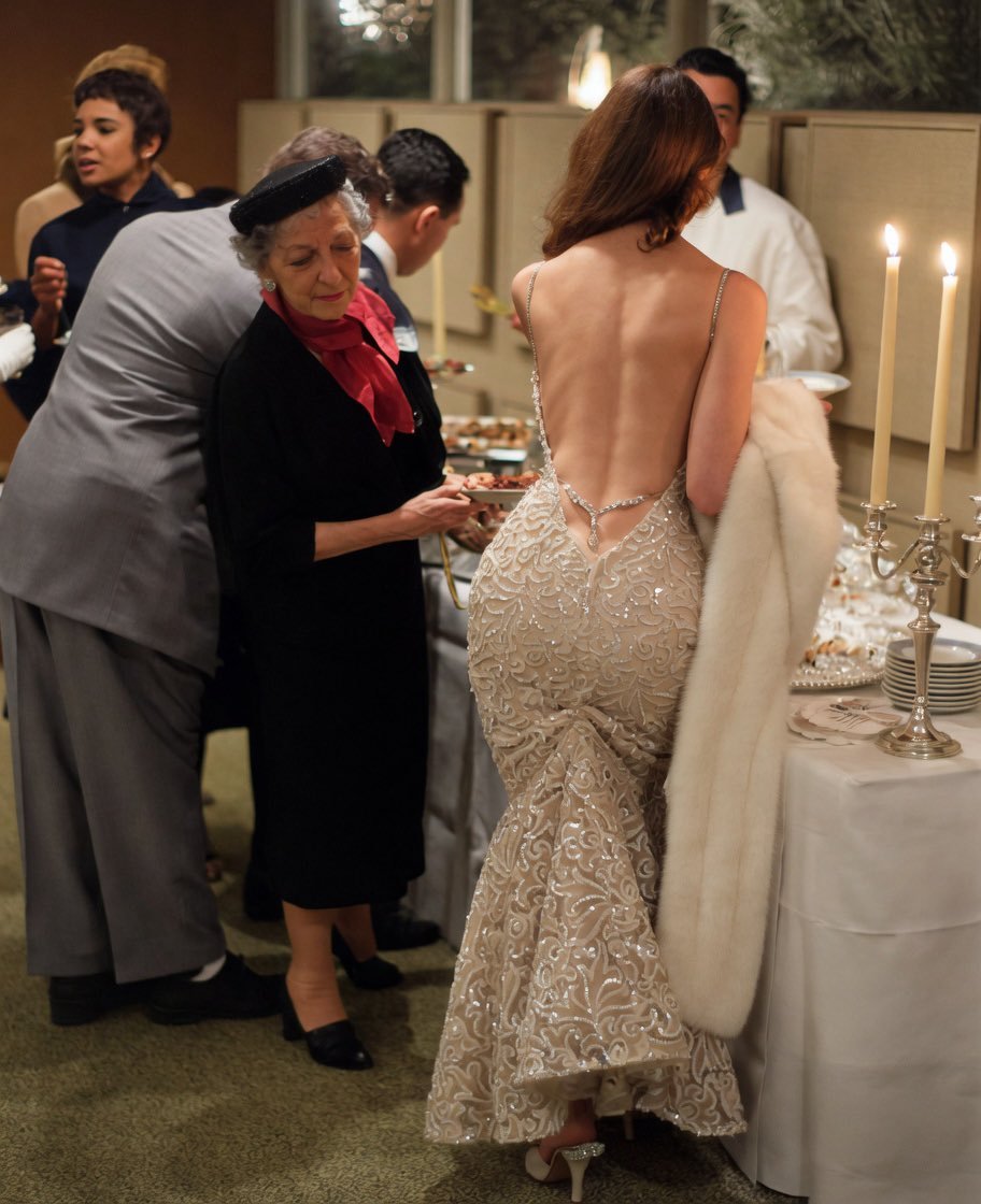 A backless, white/ silver, shimmering dr