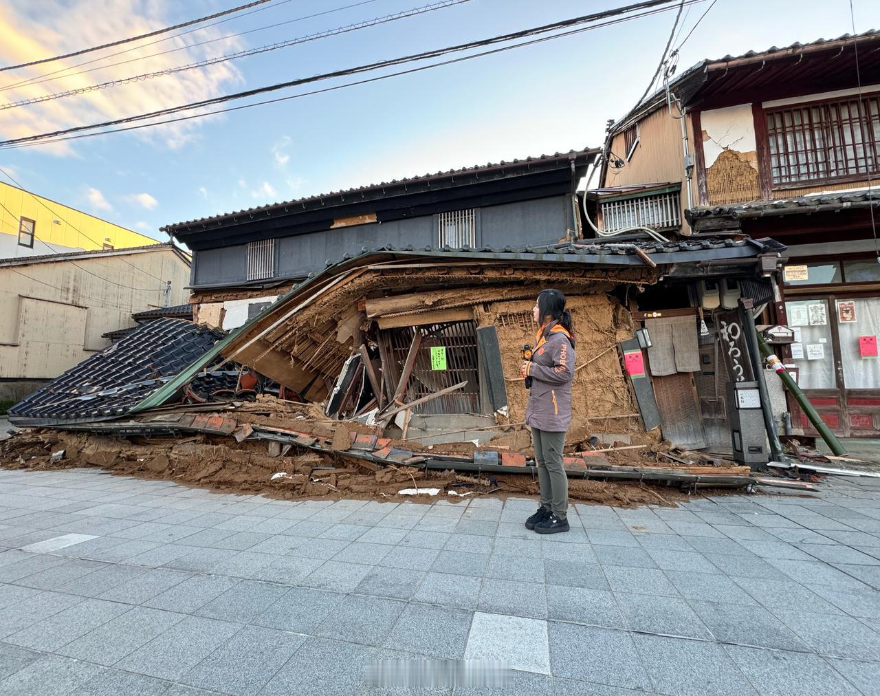 日本地震灾区，没水、没电、没食物。一位女性带着小孩，蹲在地上打井水，有人融雪解渴