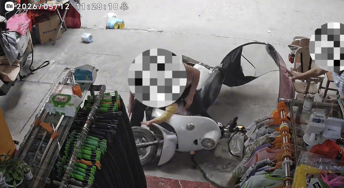 【玉林老人电车不关电门锁冲店门口摔倒】

5月12日，玉林一老人抱着小女孩坐在一