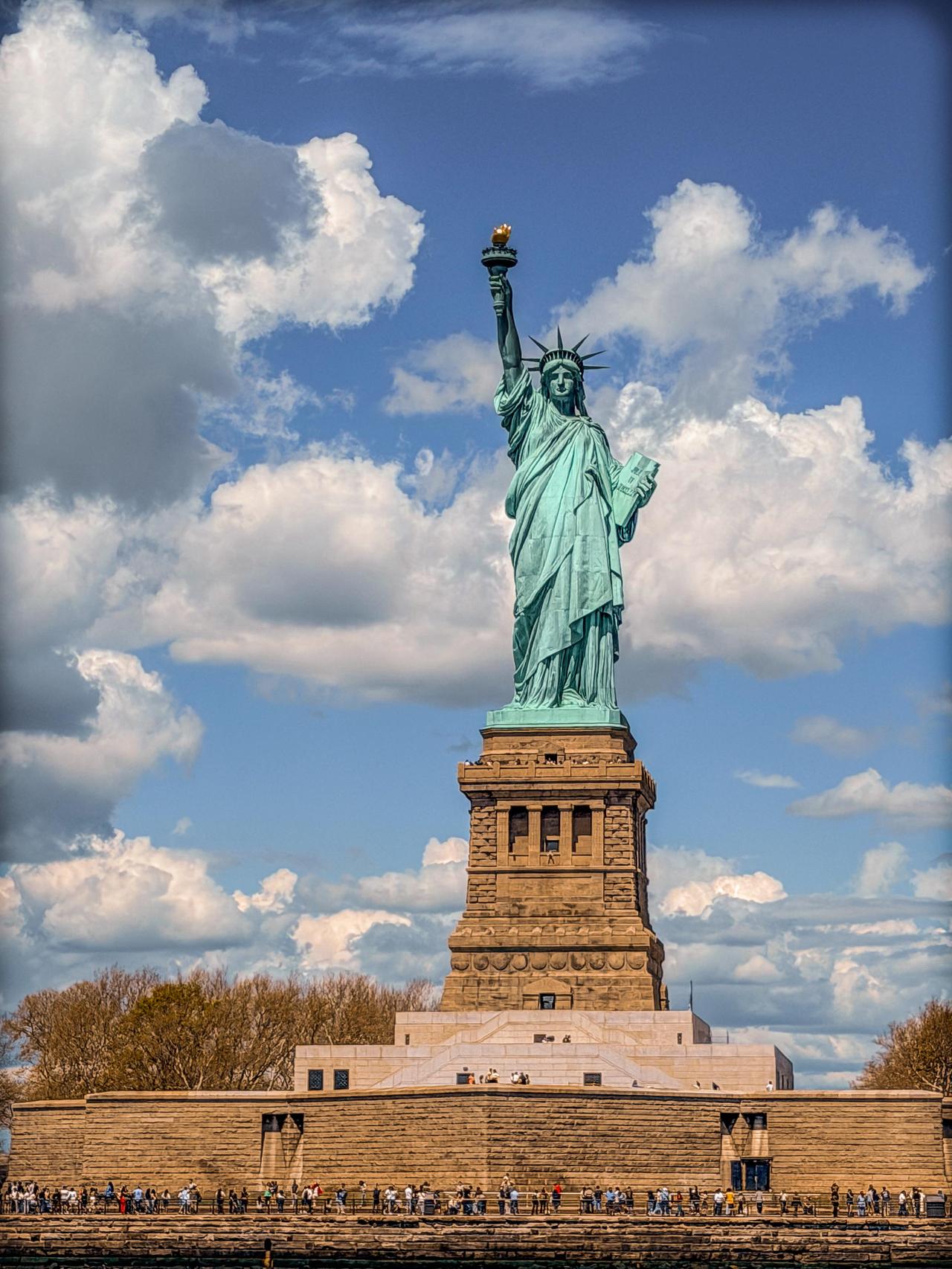 这是纽约自由女神像的近距离照片，展现了雕像的宏伟细节。自由女神像位于自由岛上，虽