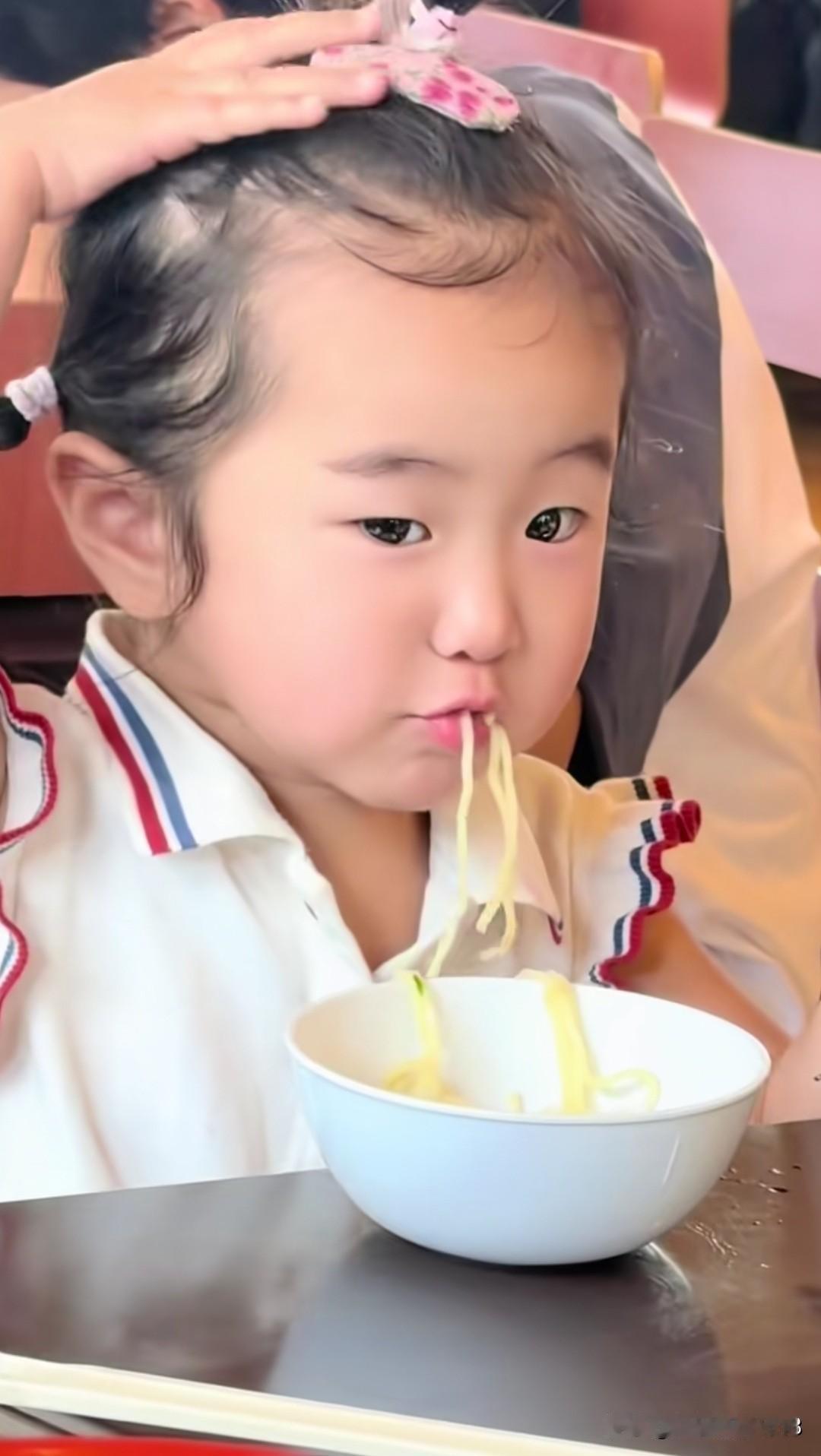 张纪中导演家的小龙珠沉浸式吃饭，她用小小的手抓起软乎乎的面条，大口大口的往嘴里塞