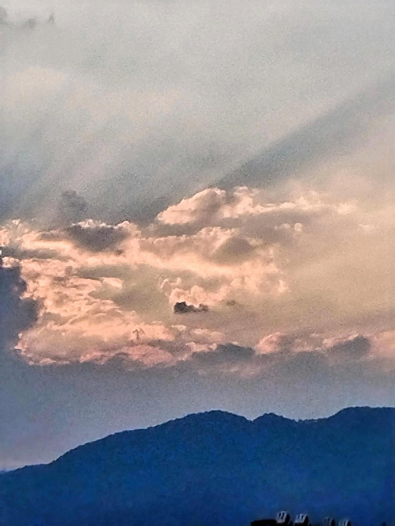 云层翻滚，夕阳染红了天边，展现出一幅壮美的画卷。