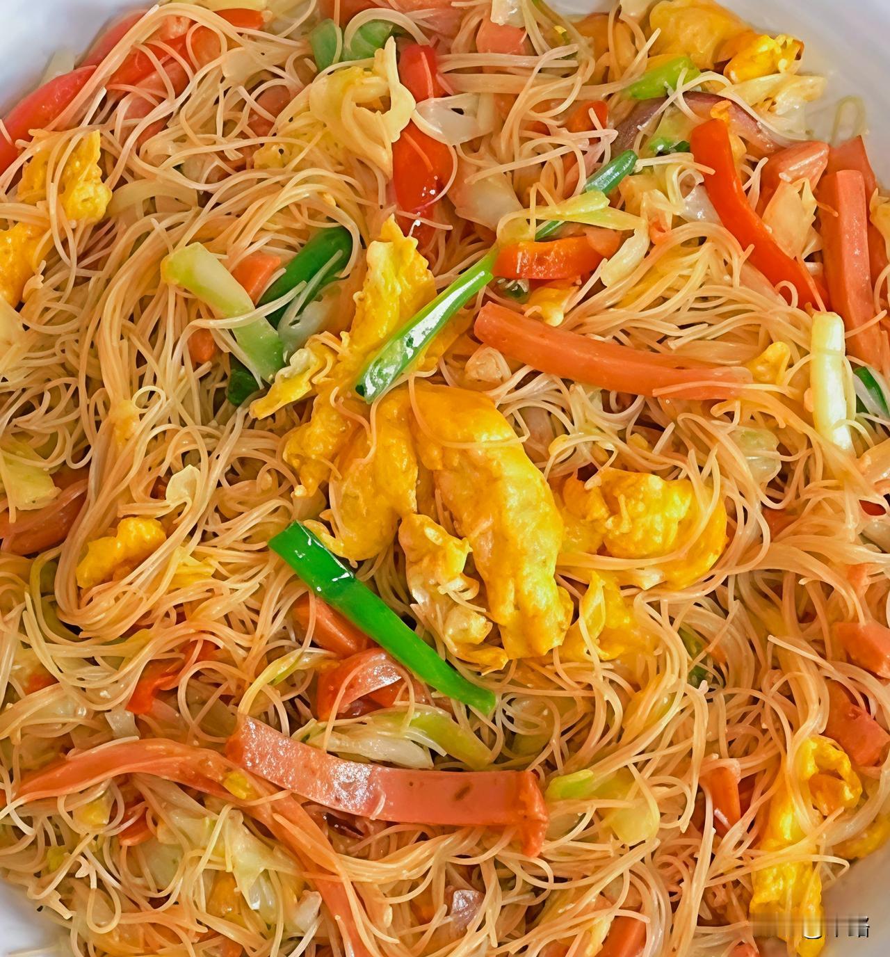 今天的晚饭，是令人垂涎欲滴的炒米粉。
刚出锅的细米粉在盘中堆叠，缕缕热气裹挟着浓