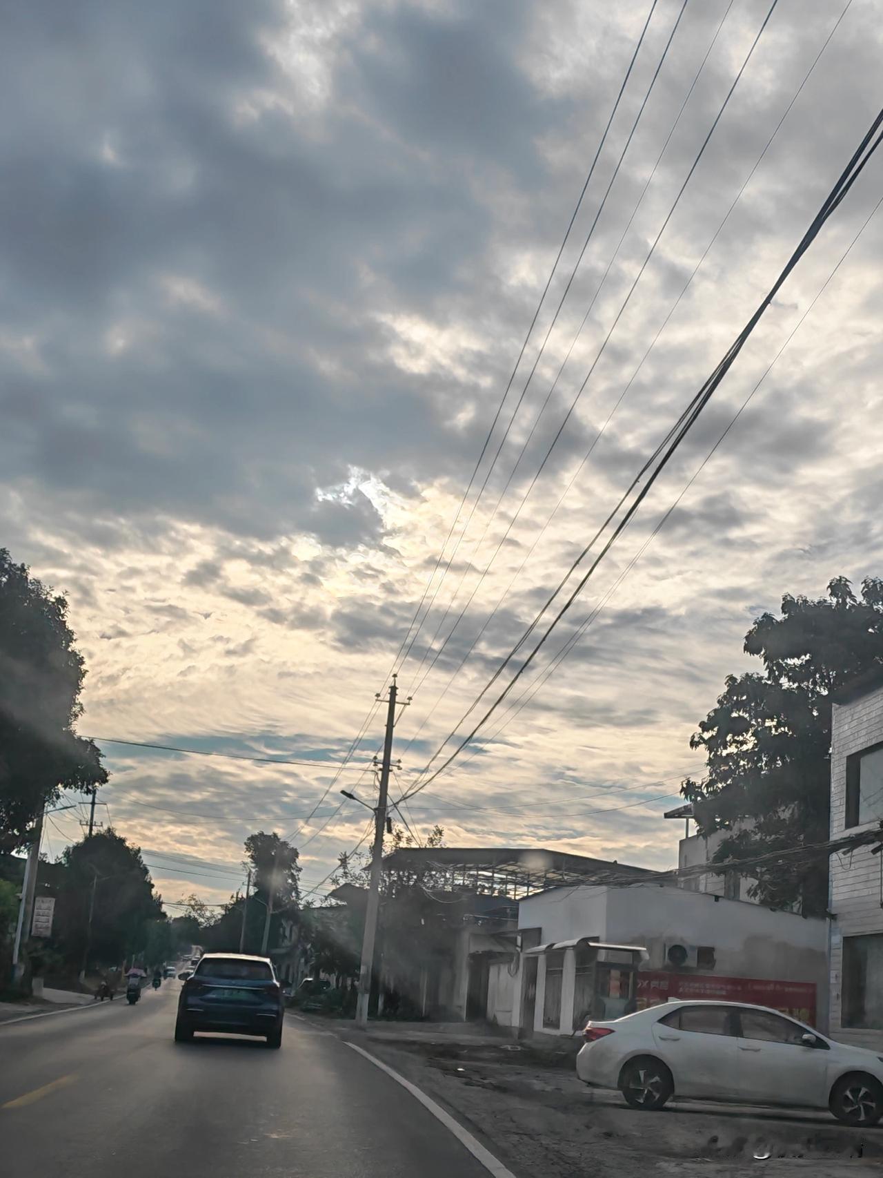 乡道清晨
 
驱车行驶在乡间公路，抬眼便是清晨独有的云天。厚重的云层铺满天空，细