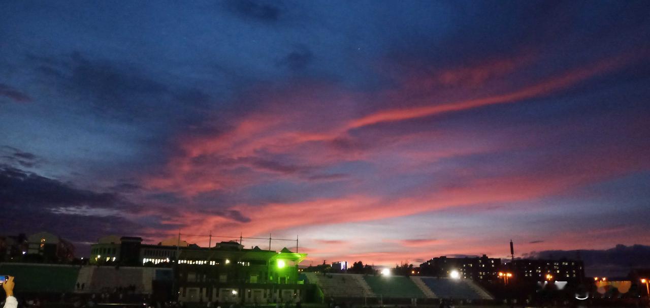 我超爱这张落日照片。照片里，夕阳西下，云层把落日揉成一片橘红，像被打翻的颜料盘。