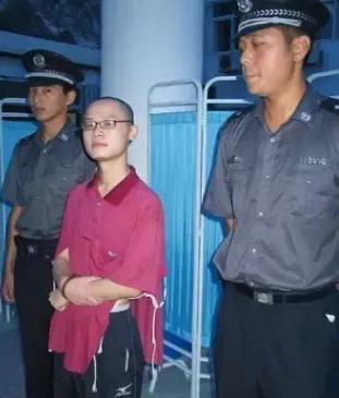 2005年，一名死刑犯被押赴刑场的镜头，这个男孩的名字叫敖力，照片中的他显得年轻
