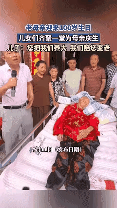 老母亲100岁啦，儿女为母亲庆生，大家围在床前，母亲躺在床上，100岁的老人了，