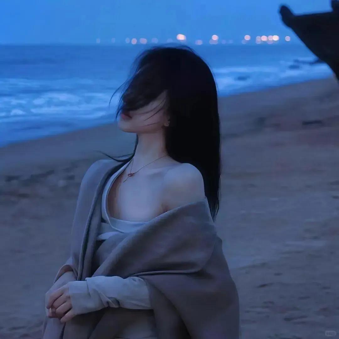 海风轻拂，长发飘逸，宁静的沙滩，沉思的瞬间。海边温柔风 晚间的海风很美 海边度假