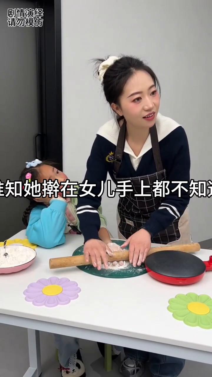 女子擀面时只顾着看电视，谁知她压着女儿手都不知道。
中午做饭时间到了，女子一边看