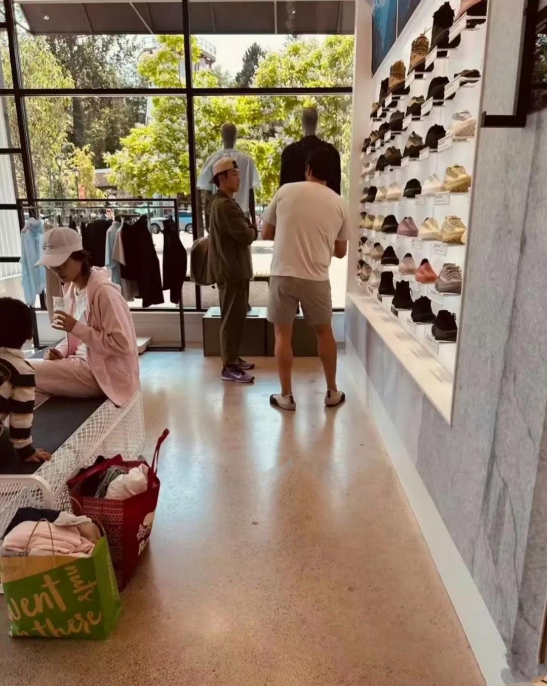 郑凯一家人现身加拿大一购物商场，他正在安心选购鞋子，身旁的老外帅哥津津有味的给他