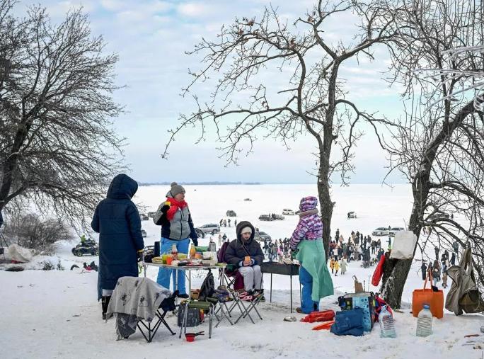 乌克兰首都基辅星期六遭俄罗斯大规模导弹和无人机袭击后，人们聚集在结冰的基辅水库（