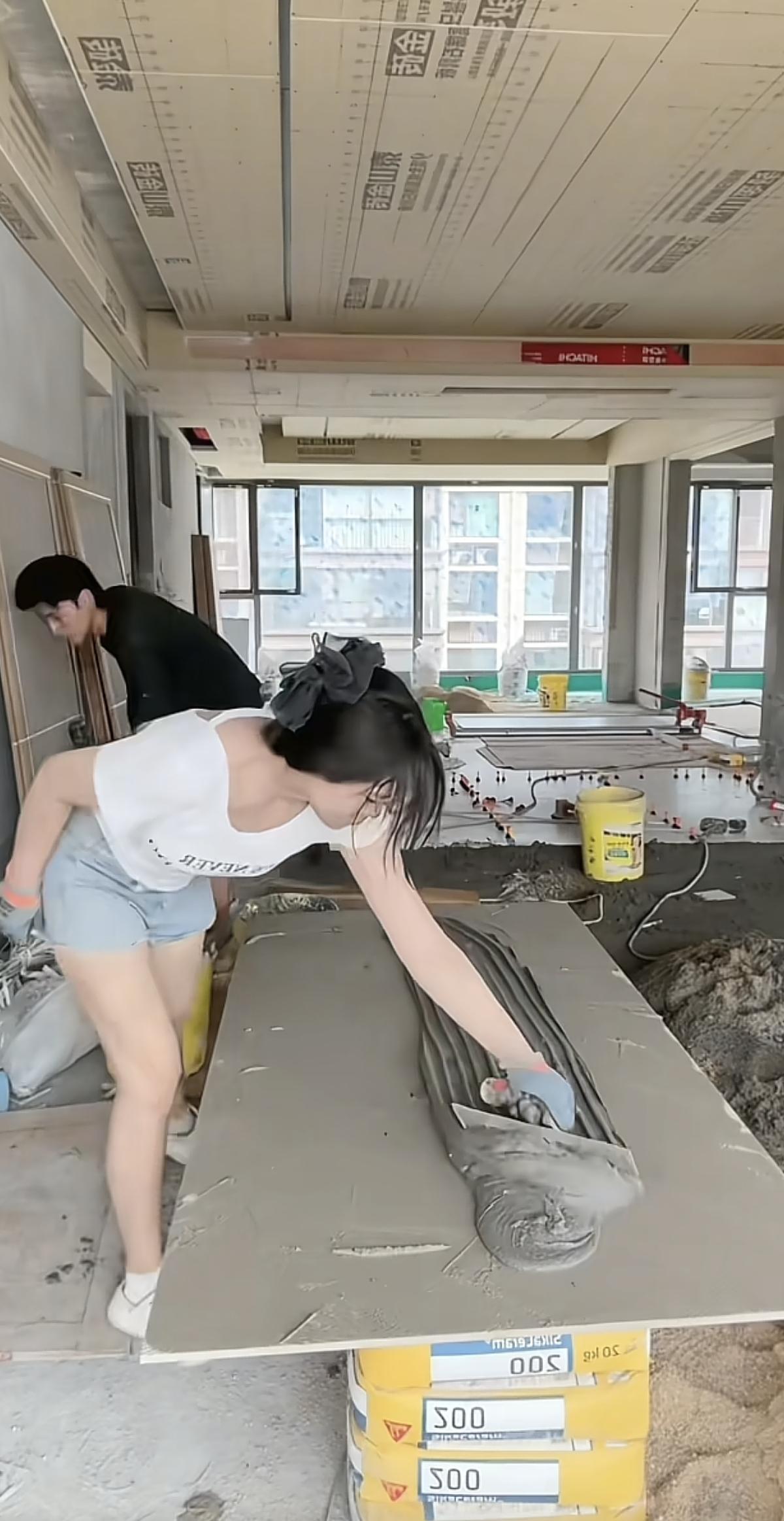 羡慕了！河南周口，一对00后小夫妻，丈夫贴瓷砖，妻子打下手，两人一个月能挣两万左