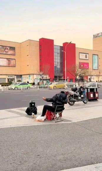 即墨区服装市场附近经常有个男人放着音乐坐在马扎上做一些夸张的动作，曾经有好奇的人