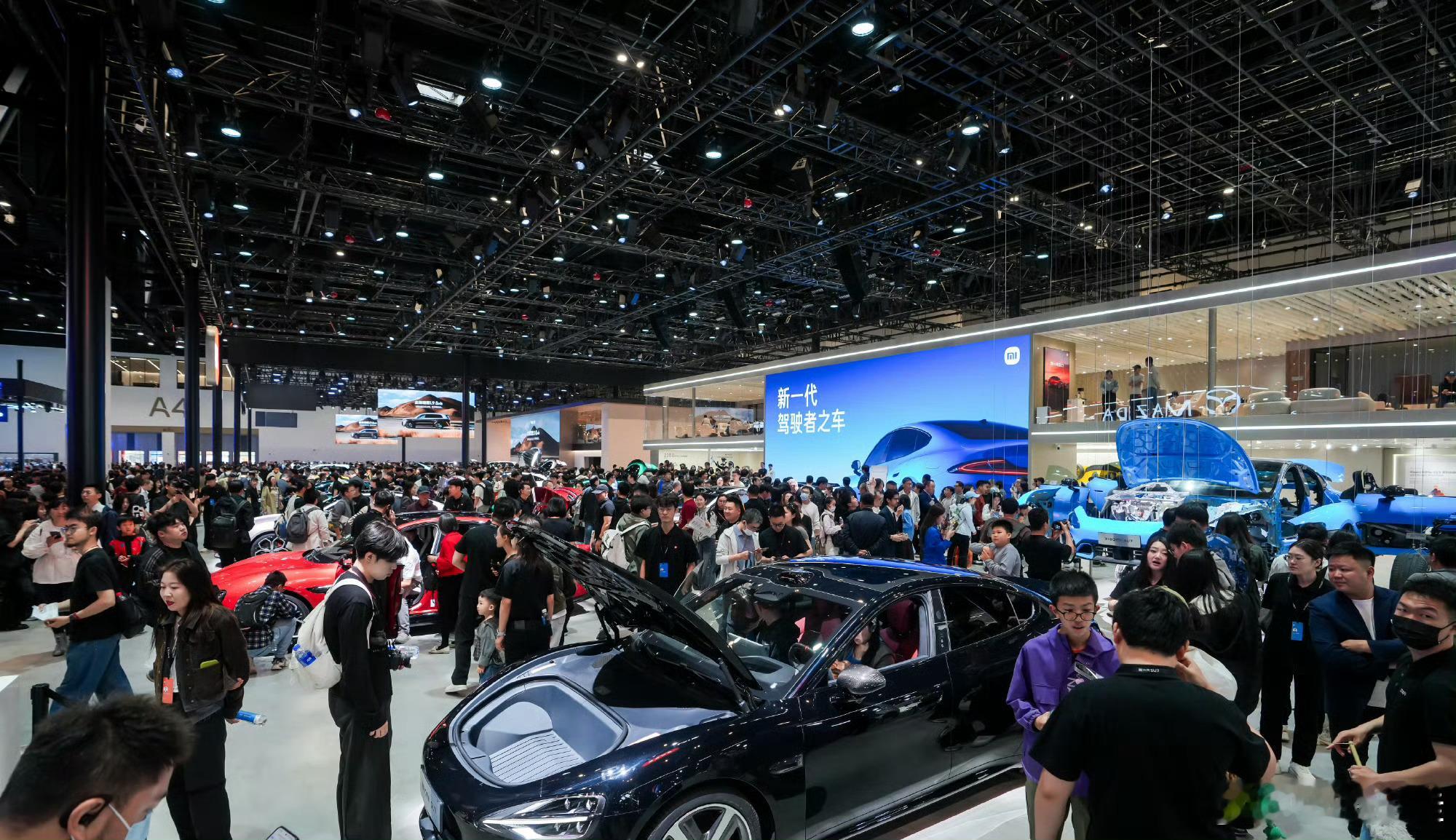 老外踮脚看中国智造在今年的北京车展上，小米展台又成顶流了！想看新一代SU7那可是