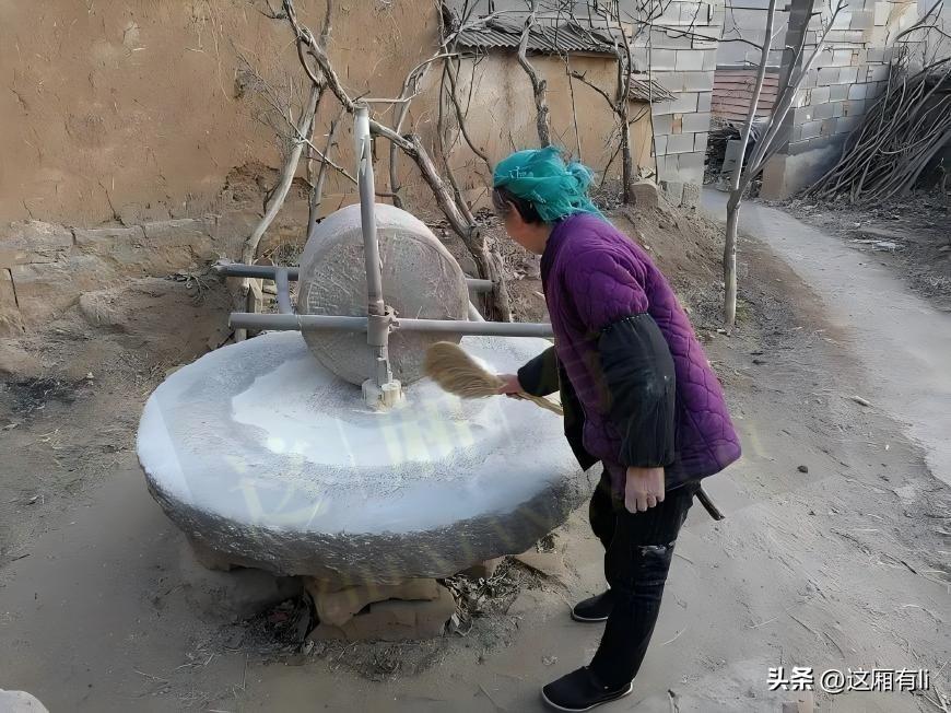 老物件,你见过哪些?
黄土院墙旁静静立着一件旧石器，粗粝石面磨出温润印记。老人拿