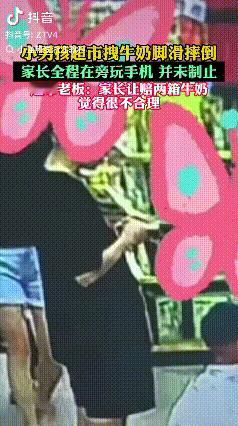 山东，一位妈妈带着孩子逛超市时，自己埋头看手机，任由身旁的孩子拉扯货架上的牛奶箱